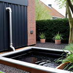 **Image Prompt:** A modern Dutch garden featuring a rainwater harvesting system. Show a sleek, dark-colored rainwater tank integrated into the landscape, connected to the house with clearly marked pipes (regenwater/drinkwater). Include a visible filter system and flourishing plants being watered by the system. The scene should convey sustainability and efficient water usage in a typical Dutch setting.
